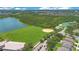 Aerial view of a neighborhood with baseball diamond, greenspace, tennis courts, and community pool at 746 Stonewyk Way, Kissimmee, FL 34744