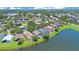 Beautiful aerial view of lakeside homes featuring private pools and lush landscaping in a vibrant community at 746 Stonewyk Way, Kissimmee, FL 34744