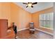 Bedroom with wood floors, desk, and seating area at 746 Stonewyk Way, Kissimmee, FL 34744