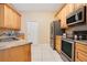 Well-lit kitchen featuring stainless steel appliances, granite countertops, and light wood cabinetry at 746 Stonewyk Way, Kissimmee, FL 34744