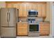 Updated kitchen featuring stainless steel appliances, and ample light wood cabinetry at 746 Stonewyk Way, Kissimmee, FL 34744