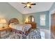 Inviting main bedroom with a ceiling fan, neutral walls, and patterned area rug at 746 Stonewyk Way, Kissimmee, FL 34744