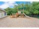 A charming playground nestled among mature trees offering a safe and fun recreational area for children at 746 Stonewyk Way, Kissimmee, FL 34744
