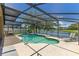 Screened-in pool with view of a fenced-in yard and lake at 746 Stonewyk Way, Kissimmee, FL 34744
