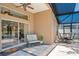 Outdoor patio with seating area and view of the screened-in pool and lake at 746 Stonewyk Way, Kissimmee, FL 34744