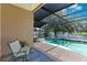 Pool with a lake view, a fenced-in yard, and patio furniture at 746 Stonewyk Way, Kissimmee, FL 34744