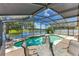 Relaxing screened-in pool area with a view of the lake, perfect for entertaining at 746 Stonewyk Way, Kissimmee, FL 34744