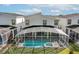 Aerial view of backyard pool and spa, enclosed with a screen, perfect for outdoor relaxation at 9126 Sommerset Hills Dr, Davenport, FL 33896