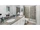 Bathroom with double sink vanity, large mirror, modern fixtures, and glass-enclosed shower at 9126 Sommerset Hills Dr, Davenport, FL 33896