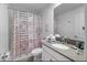 Bathroom with modern patterned shower curtain, vanity with sink, and tiled floor at 9126 Sommerset Hills Dr, Davenport, FL 33896
