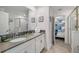 Bathroom features a double sink vanity with white cabinets and a view to an adjacent bunk room at 9126 Sommerset Hills Dr, Davenport, FL 33896