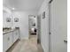 Well-lit bathroom featuring double sinks, white cabinets, and tiled floors, offering a clean and functional space at 9126 Sommerset Hills Dr, Davenport, FL 33896