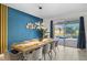 Dining area with a modern light fixture and seating for eight at 9126 Sommerset Hills Dr, Davenport, FL 33896