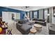 Spacious game room with a large gray sectional sofa, ping pong table, and arcade games at 9126 Sommerset Hills Dr, Davenport, FL 33896