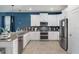 Modern kitchen with stainless steel appliances, ample counter space, and white cabinetry at 9126 Sommerset Hills Dr, Davenport, FL 33896