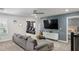 Spacious living room with modern decor and a view of additional rooms, offering a comfortable and stylish living space at 9126 Sommerset Hills Dr, Davenport, FL 33896