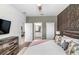 Comfortable main bedroom with an accent wall and access to a bathroom with double sinks at 9126 Sommerset Hills Dr, Davenport, FL 33896