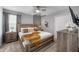 Modern primary bedroom with stylish decor, a comfortable bed, and a view of the well-lit and furnished room at 9126 Sommerset Hills Dr, Davenport, FL 33896