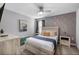 Serene primary bedroom with a textured wall, plush bedding, and modern furnishings, creating a relaxing retreat at 9126 Sommerset Hills Dr, Davenport, FL 33896