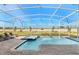 Enclosed outdoor pool with spa and lounge chairs, all surrounded by a brick patio at 9126 Sommerset Hills Dr, Davenport, FL 33896