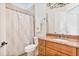 Cozy bathroom with a granite countertop, natural wood vanity, and framed mirror at 9905 Lanai View Ct, Windermere, FL 34786