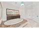 Luxurious bathroom with large soaking tub with granite surround and a dual sink vanity at 9905 Lanai View Ct, Windermere, FL 34786