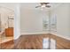 Sunlit bedroom features hardwood floors, neutral paint, and a connected bath at 9905 Lanai View Ct, Windermere, FL 34786