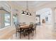 Elegant dining room with an oval table, decorative chairs, and views of the outdoor area at 9905 Lanai View Ct, Windermere, FL 34786