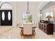 Dining area featuring a rustic wooden table and chairs, complemented by a stylish chandelier and natural light at 9905 Lanai View Ct, Windermere, FL 34786