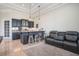 Comfortable seating area adjacent to custom wet bar, complete with barstool seating, and stylish cabinets at 9905 Lanai View Ct, Windermere, FL 34786
