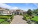 Beautiful home with manicured landscaping, lush green lawns, circular driveway, and an elegant facade at 9905 Lanai View Ct, Windermere, FL 34786