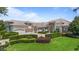 Elegant exterior elevation of a custom home featuring manicured landscaping, a circular driveway, and a three-car garage at 9905 Lanai View Ct, Windermere, FL 34786