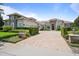 Elegant home featuring manicured lawns, colorful landscaping, a circular driveway, and refined architectural details at 9905 Lanai View Ct, Windermere, FL 34786