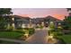 Charming home exterior with manicured landscaping and warm sunset lighting, stone accents and inviting entrance at 9905 Lanai View Ct, Windermere, FL 34786