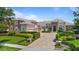 Beautifully landscaped front exterior featuring a paved drive, lush greenery and a meticulously kept lawn at 9905 Lanai View Ct, Windermere, FL 34786