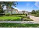 Well-maintained front yard with lush green lawn, mature trees, and manicured hedges at 9905 Lanai View Ct, Windermere, FL 34786