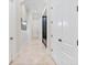 Long hallway with marble floors, decorative lighting, and white trim throughout the home at 9905 Lanai View Ct, Windermere, FL 34786