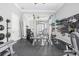 Well-equipped home gym with mirrored walls, exercise machines, and weights at 9905 Lanai View Ct, Windermere, FL 34786