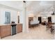 An open layout with a bar area and kitchen, leading to a cozy living area with a fireplace in the background at 9905 Lanai View Ct, Windermere, FL 34786