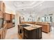 Open kitchen layout with island, countertops, modern appliances, and access to dining and living areas at 9905 Lanai View Ct, Windermere, FL 34786