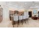 Open kitchen with an island, breakfast bar, custom cabinets, and modern stainless steel appliances at 9905 Lanai View Ct, Windermere, FL 34786