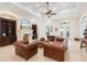 Bright and airy living room featuring a fireplace, built-in shelving, and comfortable leather sofas at 9905 Lanai View Ct, Windermere, FL 34786