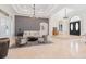 Bright living room featuring tray ceilings, neutral furniture, and ample natural light, creating an inviting atmosphere at 9905 Lanai View Ct, Windermere, FL 34786