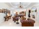 Bright living room with coffered ceilings, hardwood floors, comfortable leather seating and built-in fireplace at 9905 Lanai View Ct, Windermere, FL 34786