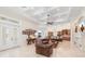 Expansive living room with coffered ceilings, tile flooring, and comfortable leather seating at 9905 Lanai View Ct, Windermere, FL 34786