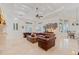 Open living area with leather sofas, a trunk-style coffee table, and elegant travertine flooring at 9905 Lanai View Ct, Windermere, FL 34786