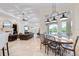 Open-concept living space with dining area, comfortable seating, and views of the outdoor area at 9905 Lanai View Ct, Windermere, FL 34786