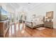 Luxurious main bedroom features tray ceilings, hardwood floors, and a seating area, creating a relaxing space at 9905 Lanai View Ct, Windermere, FL 34786