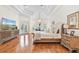 Large main bedroom boasts hardwood floors, tray ceiling, bay window, and double doors to the patio at 9905 Lanai View Ct, Windermere, FL 34786