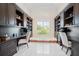 Bright office with large window, built-in bookshelves, and a dual desk arrangement at 9905 Lanai View Ct, Windermere, FL 34786